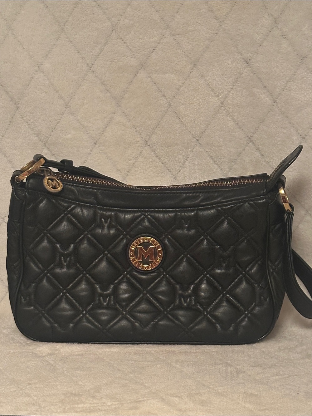 Black Quilted Leather Shoulder Bag with Gold Medallion